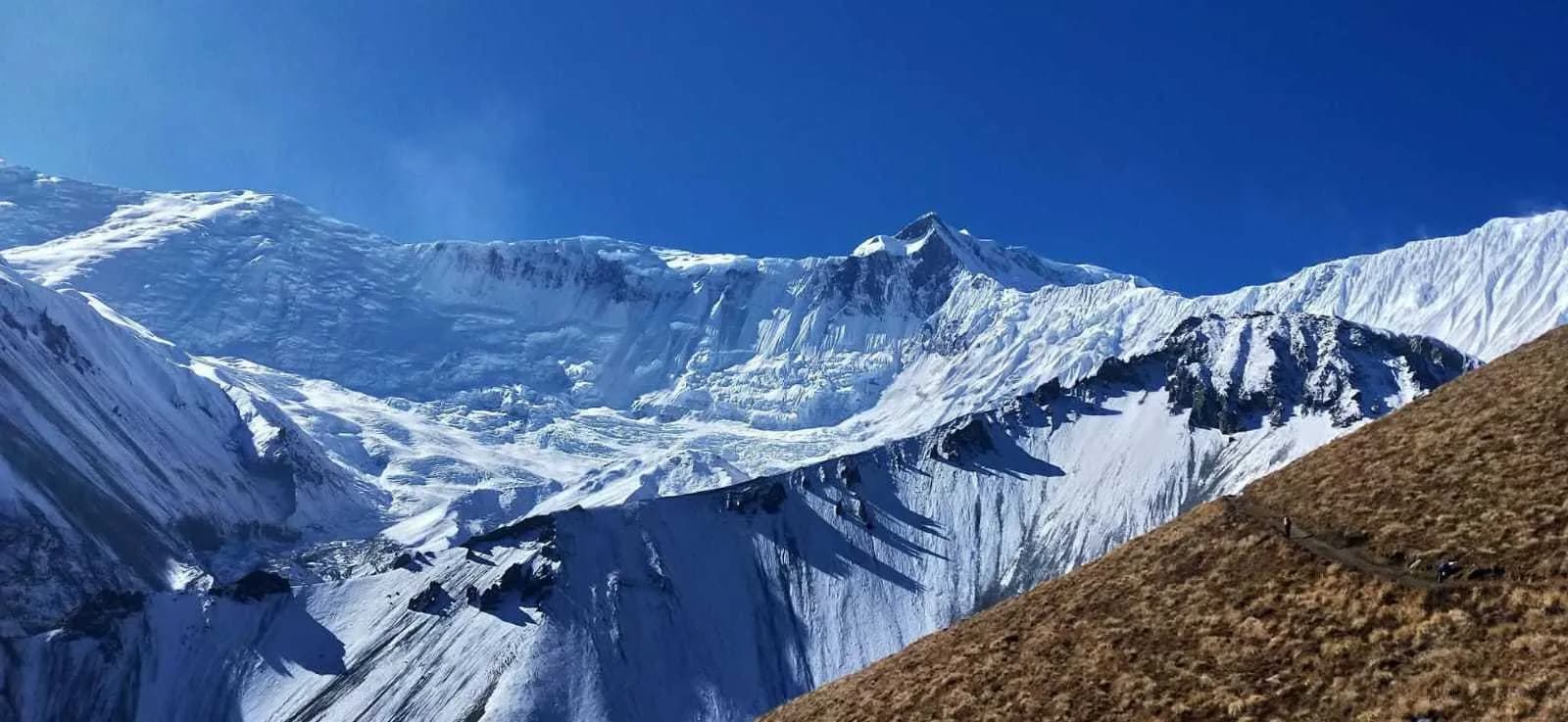 Vast snow-covered mountain ridges and glacial peaks under a bright blue sky on the Annapurna Circuit Vast snow-covered mountain ridges and glacial peaks under a bright blue sky on the Annapurna Circuit