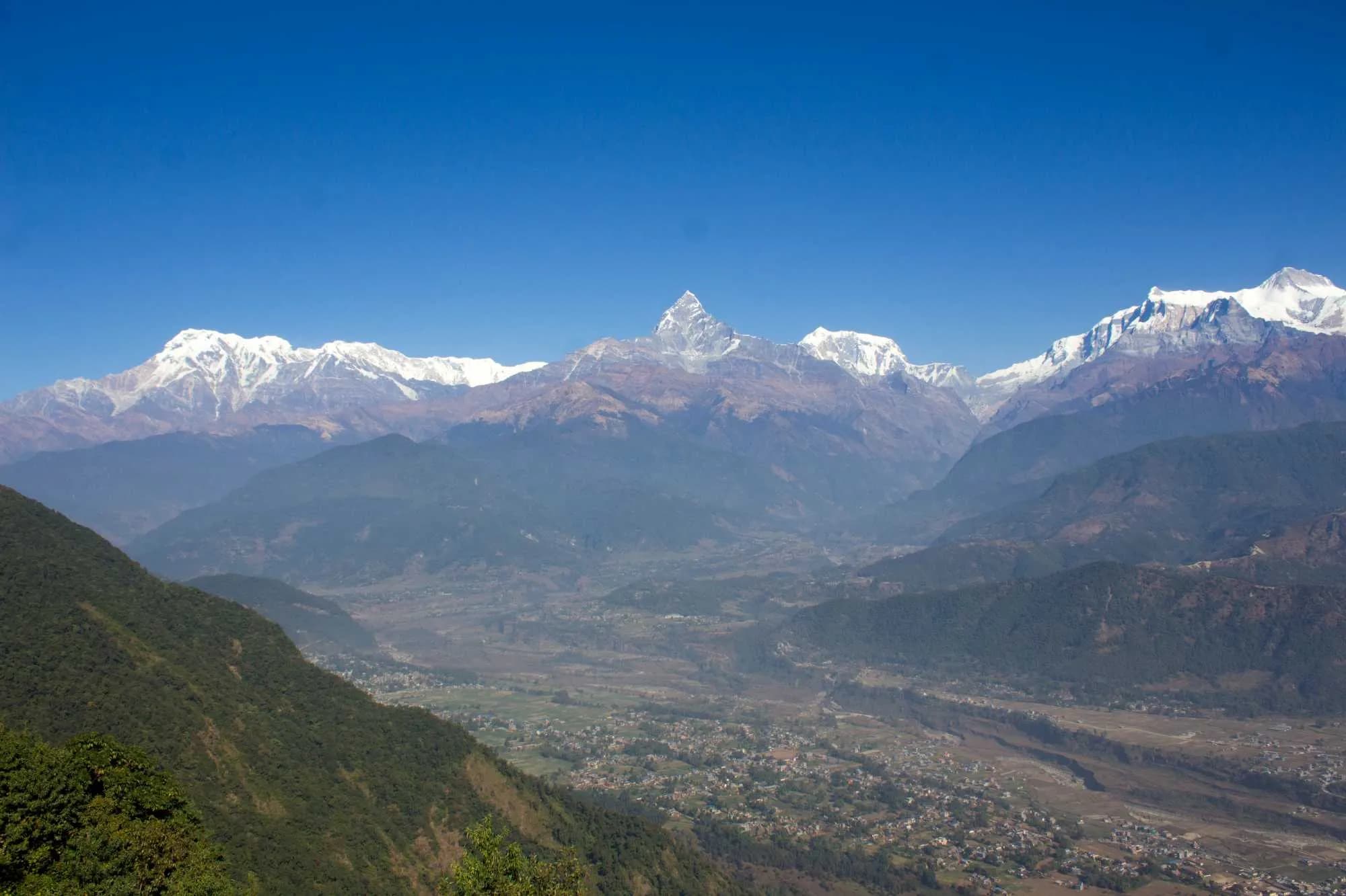 Panorama of the Annapurna mountain range and Machhapuchhre peak over a lush valley Panorama of the Annapurna mountain range and Machhapuchhre peak over a lush valley